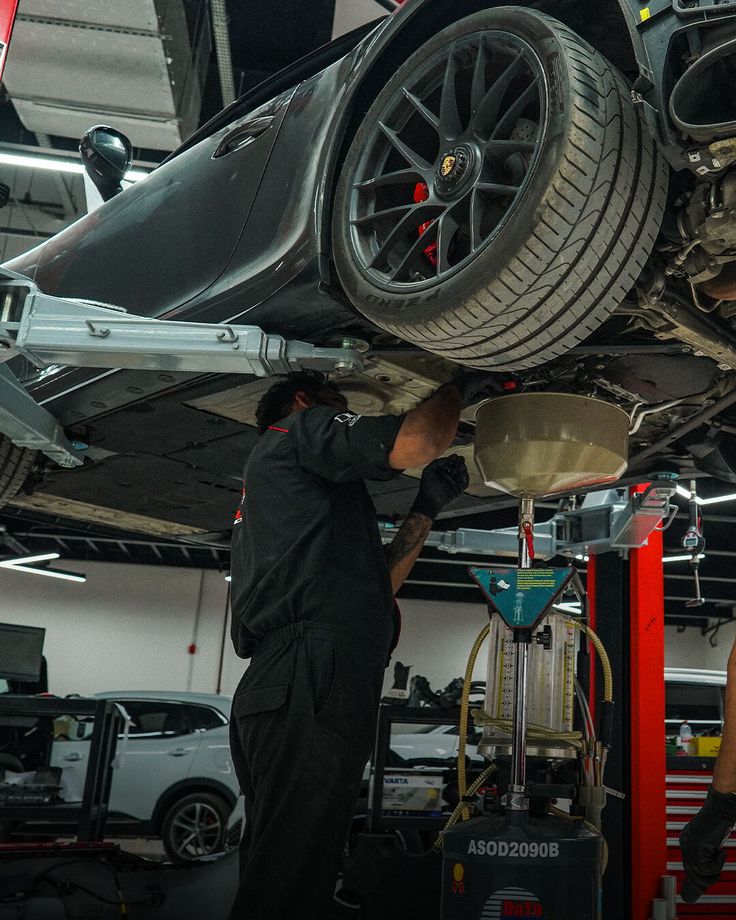 Technician applying PPF to a luxury car